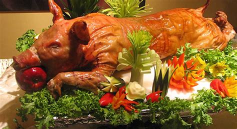 The Elaborate Process of Preparing a Living Hog for the Dinner Table